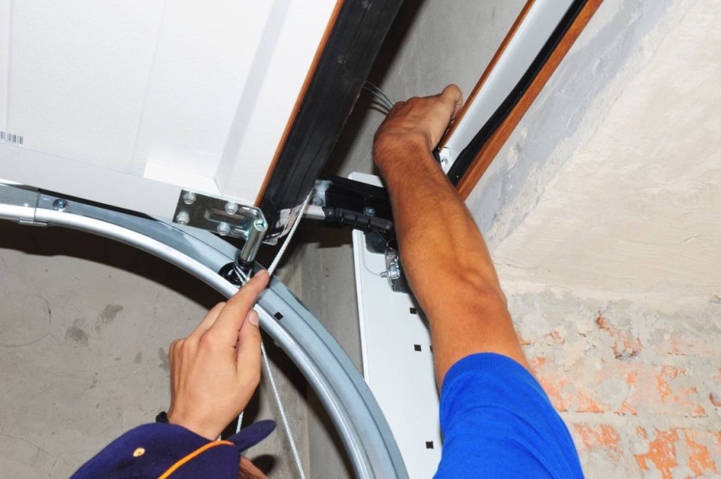 Professional contractor fixing garage door