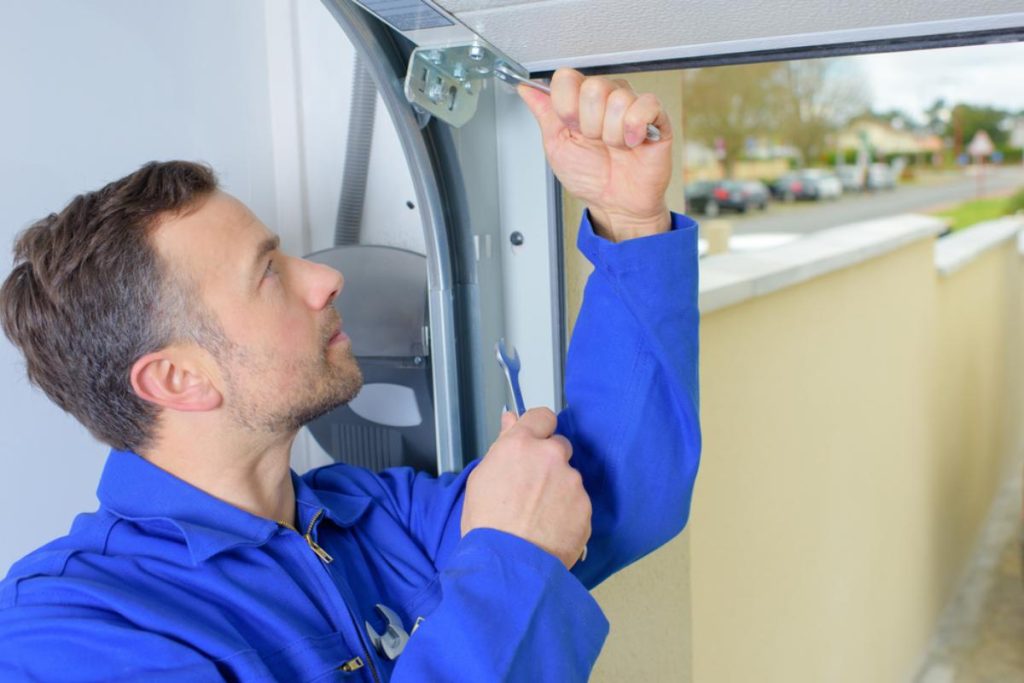 Professional Man installing a garage door