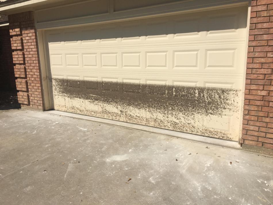 A hurricane resistant garage door with a water line from flooding.