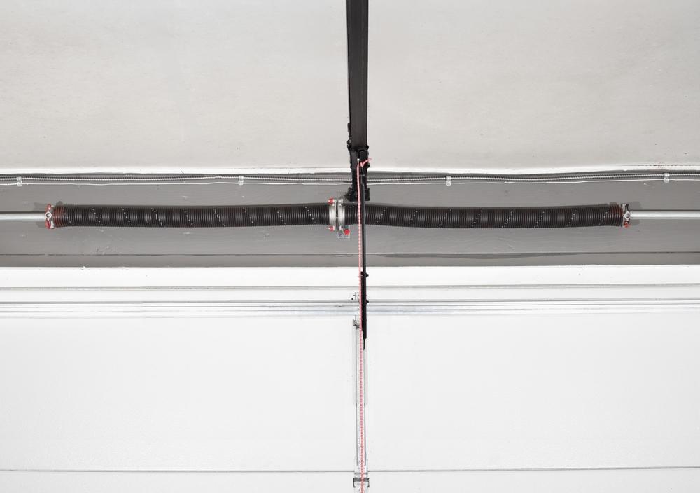 An overhead photo of torsion springs above a garage door.