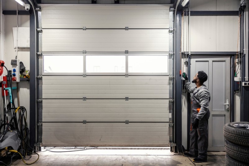 Workman servicing garage door