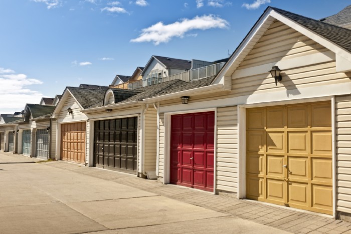 A row of garages with colorful garage doors.